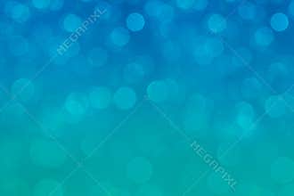 Bokeh soft pastel aqua and blue background with blurred rainbow lights.