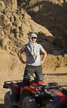 Man near ATV in desert