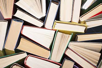 Open book, hardback books on wooden table. Education background. Back to school. Copy space for text.