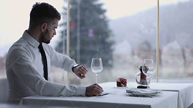 Handsome man with mobile phone in restaurant
