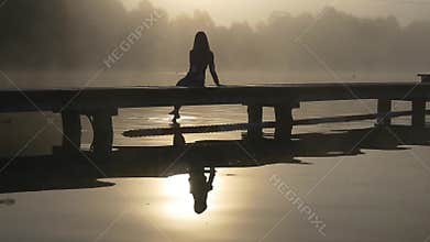 Woman on the dock in the mist