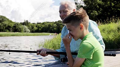 Grandfather and grandson fishing on river berth 9