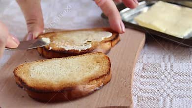 Spreading butter on the toast