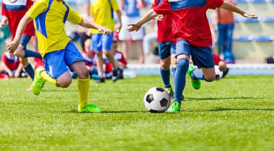 Youth football soccer match. Kids playing soccer game on sport field