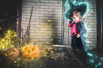 Little witch making a magic potion at Halloween night. Horror.