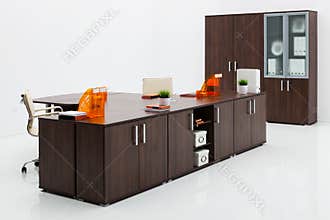 Desk, chair and bookcase on white wall