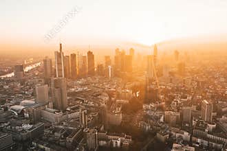 Incredible View of Frankfurt am Main, Germany Skyline in on Hazy Winter morning in Beautiful Sunrise Light