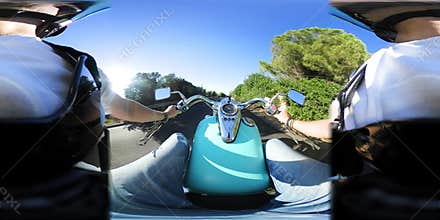 360 degree video of a motorcycle riding on a coastal road at sunset