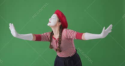 Mime artist greeting and showing heartfelt gratitude towards her fans from the stage