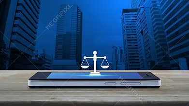 Law flat icon on modern smart mobile phone screen on wooden table over office city tower and skyscraper, Business legal service on
