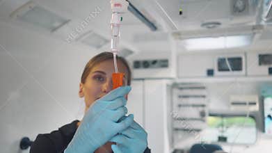 Paramedic looking after the drop injection in an ambulance
