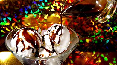 Liquid chocolate is poured on the ice-cream
