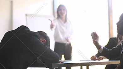 Diverse corporate staff mock and take pictures of sleeping colleague