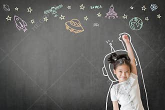 Kid`s learning inspiration in science education with girl child`s imagination doodle on teacher`s chalkboard
