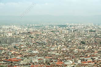 Aerial view of Marseille, with a focus on Belsunce and Saint Charles, districts with a high urban density, during a polluted day.