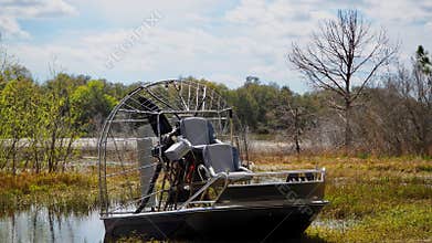 Airboat Parked on Shore in Florida Wetlands