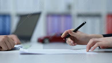 Woman buying a car and signing the contract