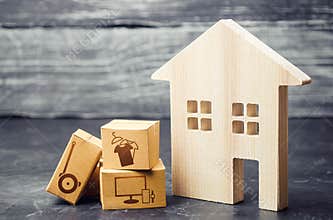 House and boxes with delivered ordered goods. Reorientation of business to online services and network sales. Convenient and fast