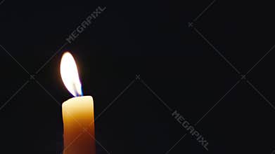 Candle flame in darkness
