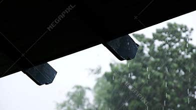 Rainy Day Concept. Rain Falling into the Roof. Static shot