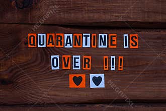 Quarantine is over paper letters sign on wooden background. Opening borders between countries. End of Lockdown news