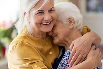 Woman hugging her elderly mother