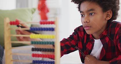 Boy using abacus at home