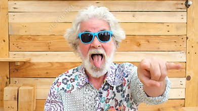Handsome happy senior aged alternative diverse caucasian mature man in front of the camera in funny and nice portrait - cheerful r