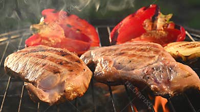 Two pork steaks are fried on bbq