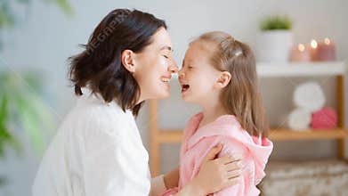 Mother and daughter caring for skin.