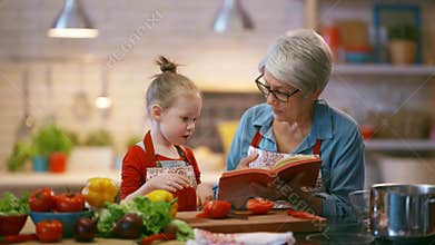 Grandma and child are preparing the vegetables.
