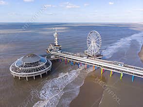 Pier with Ferris Wheel at Northern Sea Scheveningen Beach , located near the Hague city aerial drone footage. Popular