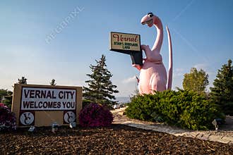 Sign for Vernal Utah, with its famous pink dinosaur statue, taken at dusk
