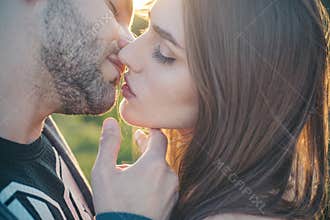 Sensual Kiss. Close-up of beautiful passionate couple kissing. Sexy couple In Love. Intimate relations. Mouths kissing