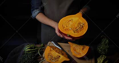 Autumn harvest - woman holding pumpkin in hands. cross section
