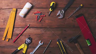 Home improvement and repair concept - work tools and objects on wooden table. top view copy space stop motion animation