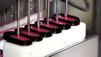 Production decorative cosmetics for lips in factory. Cosmetic industry