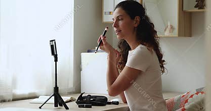 Makeup artist record videovlog holding eye brush gives professional advice