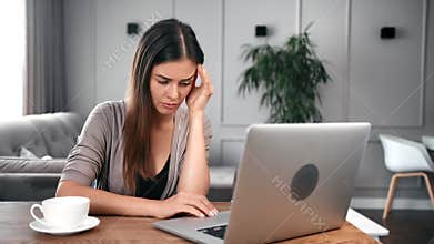 Upset young female feeling tired massaging temples sitting at desk. 4k Dragon RED camera