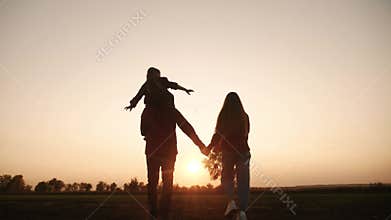 Happy family walking together in the park silhouette. Friendly family kid dream concept. Happy outdoor family walking