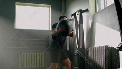 Sportsman Throw Heavy Ball at Wall .