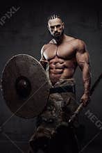 Nord warrior with shield and axe posing in dark background