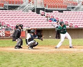 Baseball player swinging at ball..