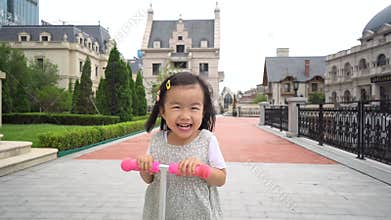 Chinese girl is riding a scooter