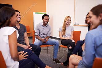 Multi-Cultural Group Of Men And Women At Mental Health Group Therapy Meeting