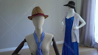 Female mannequins fitting on stylish clothing, accessories and apparels standing in showroom or shop.