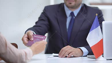 French consular officer giving passport to woman, refugee visa, asylum status
