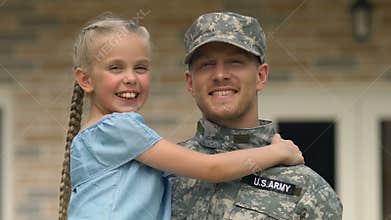 Joyful daughter looking at father military uniform, soldier homecoming, patriot