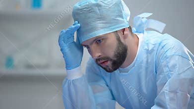 Shocked surgeon thinking about last unsuccessful operation, responsible work