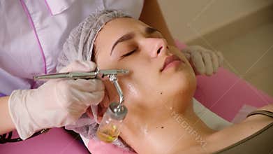 cosmetology beauty clinic.Professional cosmetologist conducts cell oxygenation for the face Ozone treatment with